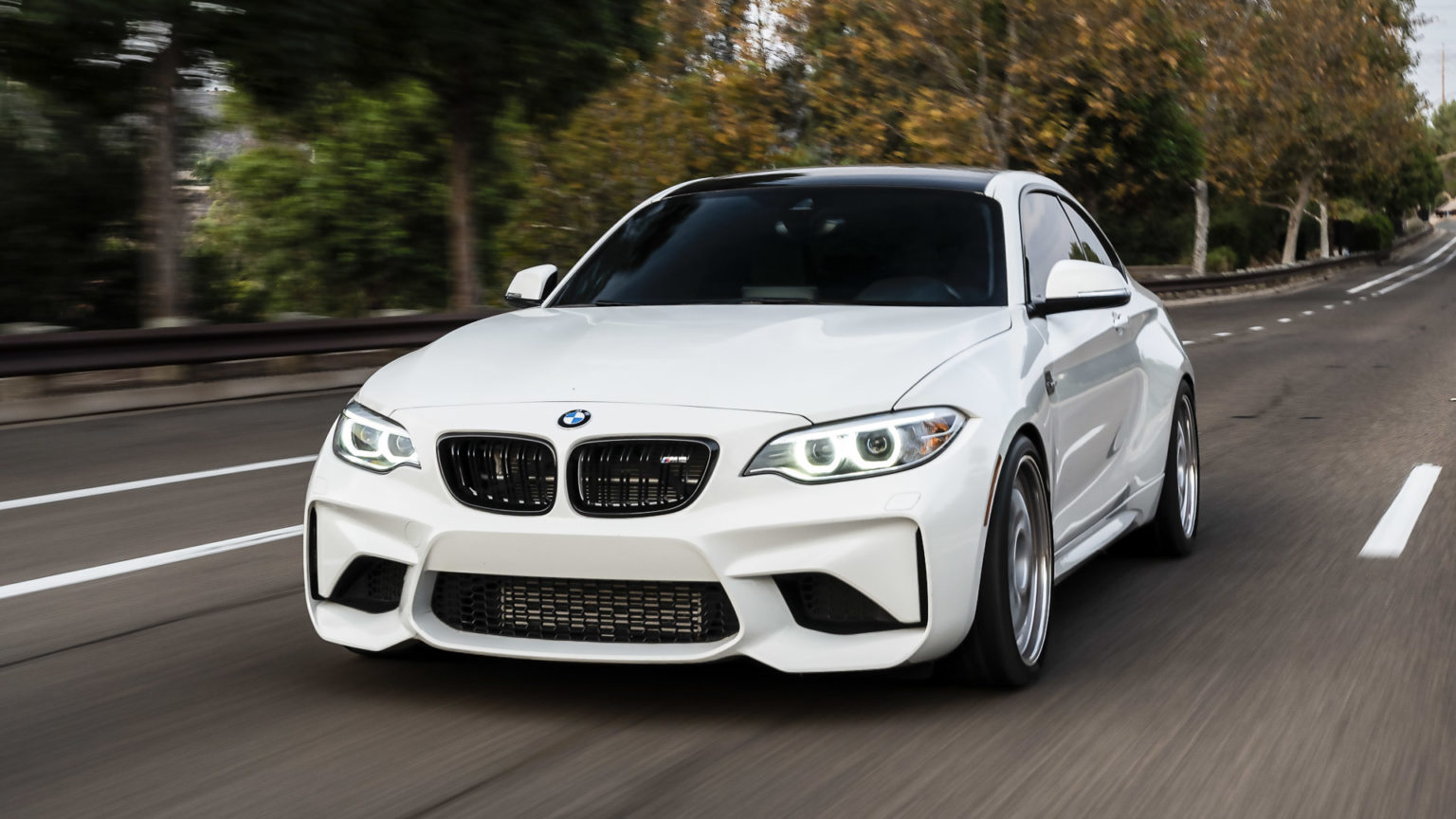 BMW M2 with full Ultimate Armor — full-front PPF and Ceramic Pro coating, cruising at speed